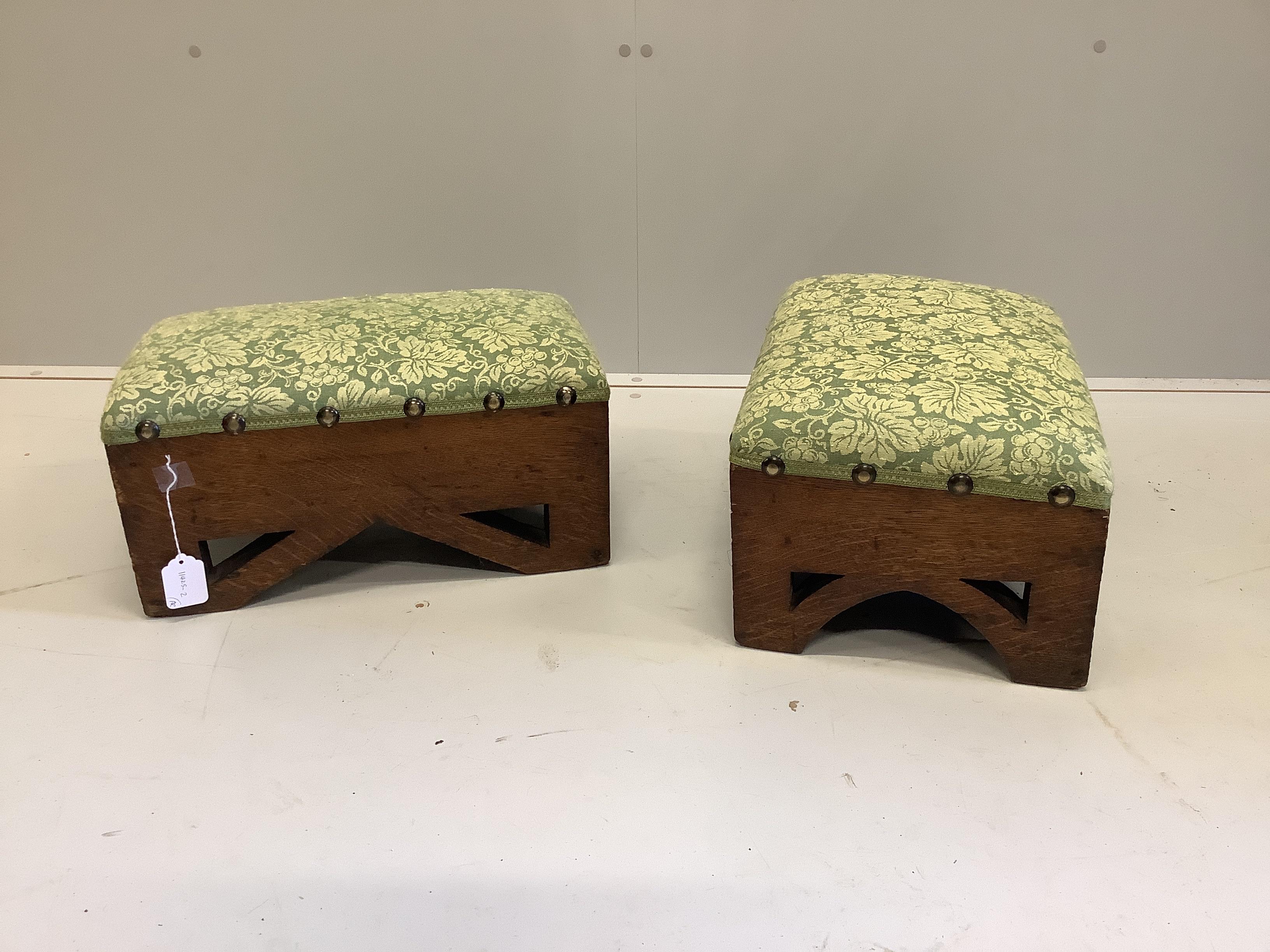 A pair of rectangular Gothic style oak footstools, width 46cm, depth 30cm, height 23cm